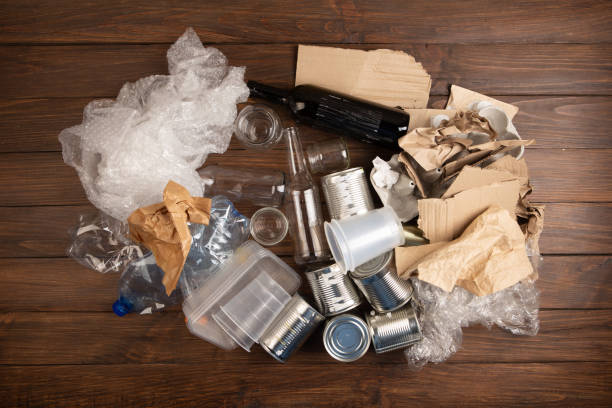 istock Recycling and ecology concept. Sorting household waste - plastic, paper, metal, captured from above, flat lay. Wooden background 2149657984