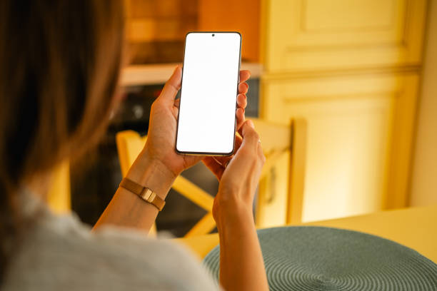 istock Over the shoulder view on blank telephone screen. 2149658666