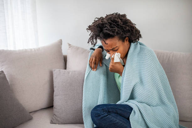 istock Woman with flu in bed, she use home medicine to handle sickness. 2149658856