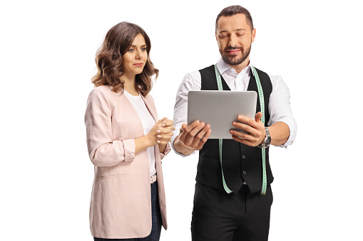 Tailer and a young woman looking at a digital tablet isolated on white background