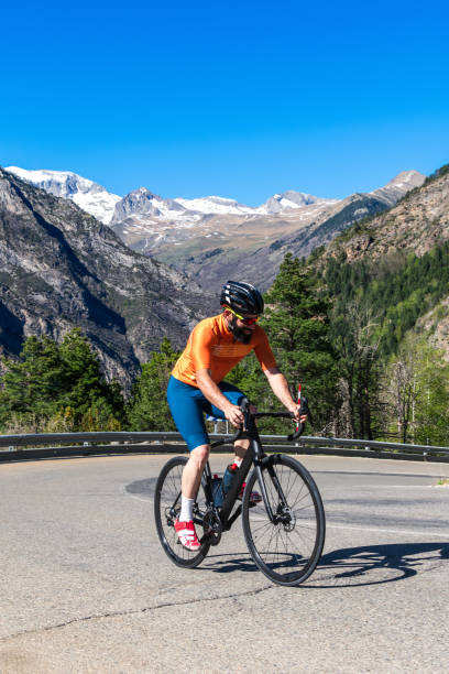 istock A man is riding a bicycle on a mountain road 2149660588