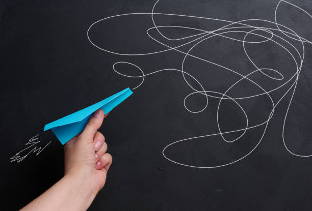 istock A hand holds a paper airplane with a drawn flight trajectory on the board, representing the concept of support and mentorship 2149662937