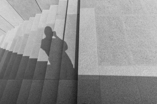 istock There is a shadow of a person on the stone steps 2149665686