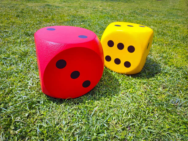 istock Close-up of bright large dice on the grass. 2149666419