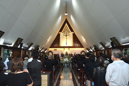 Bangkok, Thailand April,12 2024 :  people on funeral in church at Wat Mae Phra Prachak Mueang Lourdes Church, Bangsakae community of Christian in past and harmony to Thai people until now