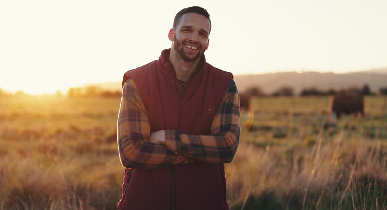 Face, countryside and man with arms crossed, farming and lens flare with a smile, environment and agriculture. Portrait, person or farmer with stock, sustainability and nature with happiness or field