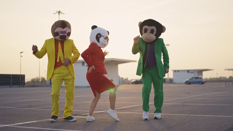 Friends with mascot masks dancing and having fun