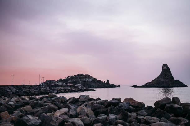 istock sea ​​stacks of Acitrezza at dawn 2149672682