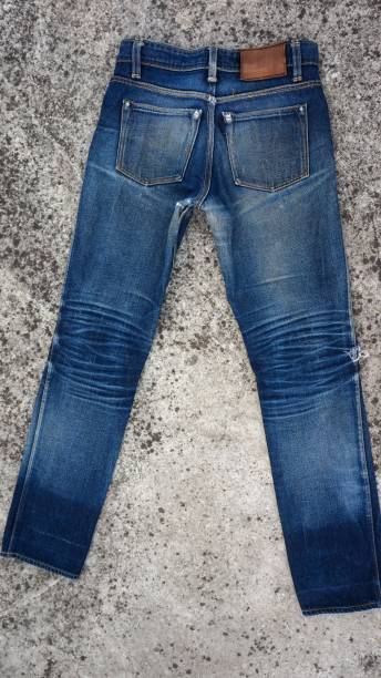 istock Blue jeans pants with faded back, with floor background 2149673878