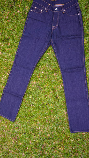 istock Indigo colored jeans pants, with grass background 2149674109
