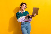 Photo of pretty nice young girl use apple microsoft laptop wear shirt isolated on yellow color background