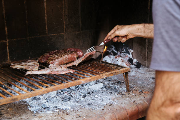 istock Man cooking the meat on the fire. 2149675309