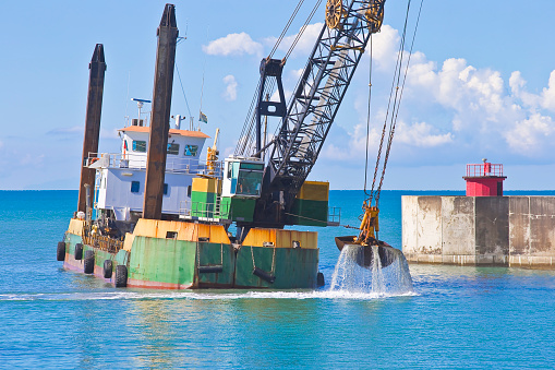 Ship for dredging the silted seabed in the Italian harbour of Marina di Pisa - Italy.