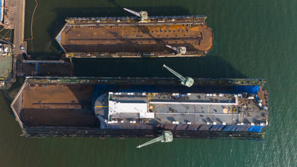istock Dry dock with Cargo Ship maintenance or repair at floating dock in shipyard both deck crane loading during bring ship in to the dry dock. 2149676627
