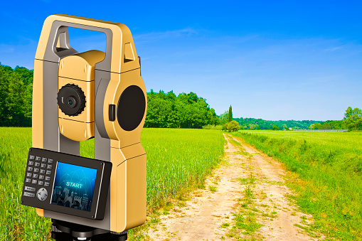 Natural landscape with footpath and 3D rendering of a geodesic device, called Total Station used for the survey of topographic maps and topographical survey