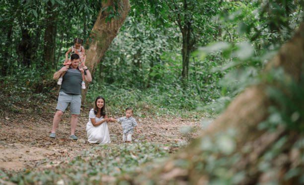 istock Diverse family multi generation having fun exploring nature in the forest traveling new experience relaxes together with hapiness moment 2149678628