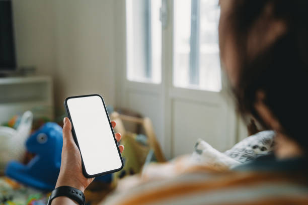 istock A woman is using her mobile phone at home 2149680710