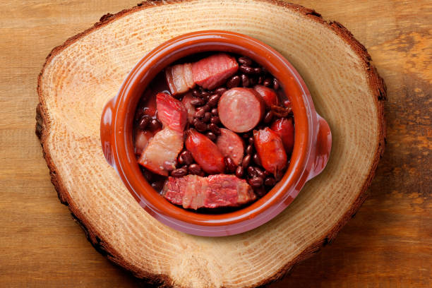 istock brazilian feijoada in ceramic bowl isolated on rustic wooden background. Copy space 2149680834