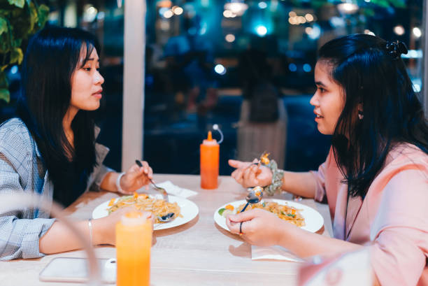 istock Women eating  together in cafe 2149681333