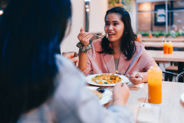 istock Women eating  together in cafe 2149681356
