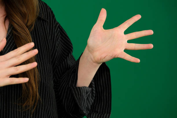 istock Young girl emotionally shouts expression of emotions with hands unrecognizable people hands palms fingers close-up on a green background chromakey feelings 2149681480