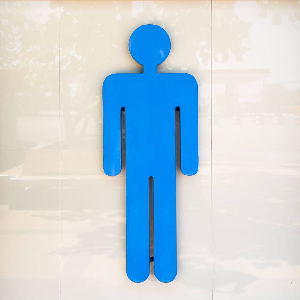 Large blue men's toilet sign on a tiled wall. Copy space background