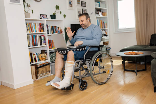 istock Man in wheelchair video conferencing 2149681857