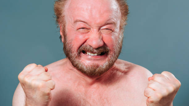 istock man aged front view looking at camera clenched teeth holding his hands in front of him in fists 2149683128
