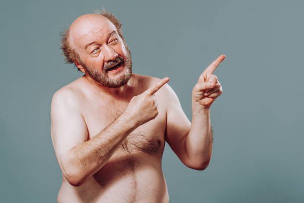 istock Front view elderly man stand from left looking to right pointing there index fingers of both hands. 2149683151
