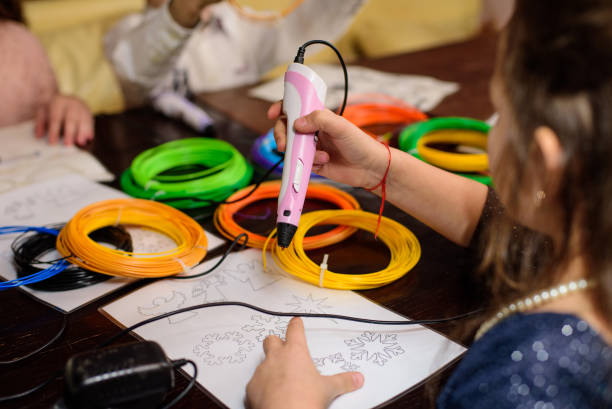 istock Children draw by 3d printing pen, working by melting ABS plastic 2149683189