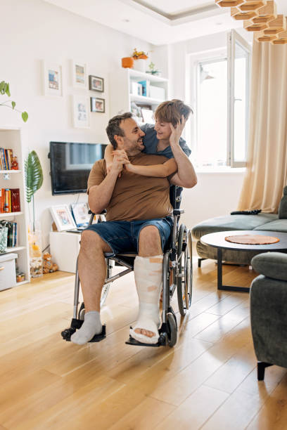 istock Son tenderly embraces his wheelchair-bound father 2149683226