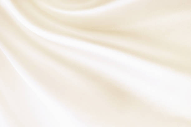 close up of white peach color  wavy blurry fabric background