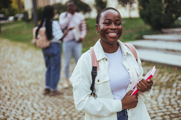istock Happy university student going on a class at the university and looking at camera. 2149683634