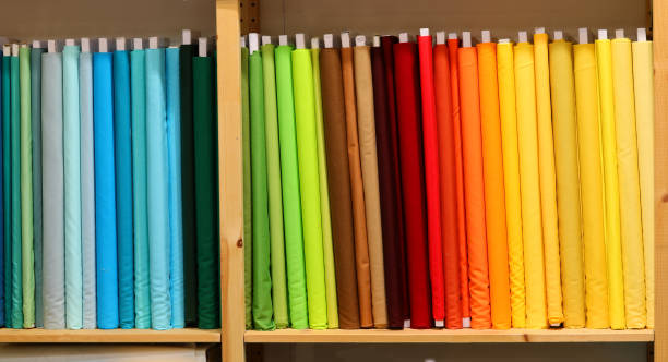 istock Display shelf in a textile factory overflowing with fabric samples for tailors to purchase 2149684284
