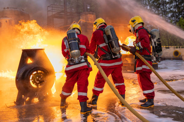 istock Firefighters Controlling Flame with Foam Spray at Dusk 2149685638
