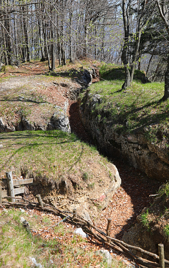 Narrow communication  trench dug in the ground for the protection of soldiers of the army during the war from enemy attacks