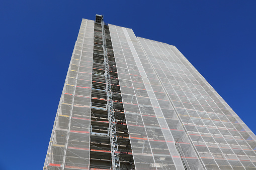 scaffolding of the gigantic skyscraper during maintenance to install the thermal insulation for energy saving without people