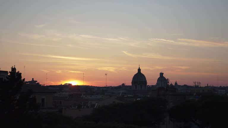 Panoramic view of Rome at sunset with St Peter Cathedral at horizon