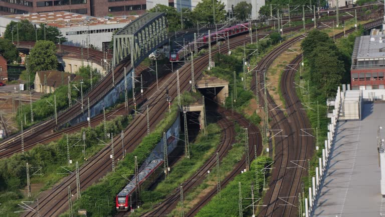 Public transportation of S-Bahn regional suburban metro speed trains drive in Cologne tracks at sunset in Germany, aerial shot