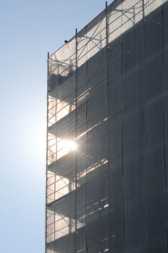 scaffolding of the condominium during maintenance to install the thermal insulation for energy saving against the light without people