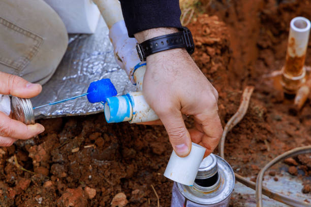 istock An experienced plumber applies glue to a pvc pipe before it is glued 2149686969