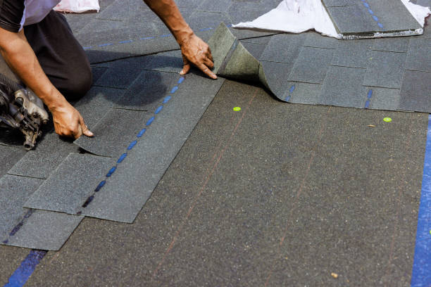 istock Construction worker installing new bitumen shingles on roof house 2149686982