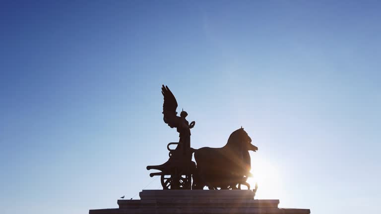 Sunset scene of Quadriga sculpture on top of Monument Vittorio Emanuele, Altare della Patria or Altar of the Fatherland, Piazza Venezia, Rome Italy
