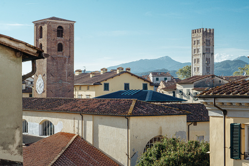 Panoramic view at sunset of the tower in italy, tuscany, lucca, Guinigi Tower, clock on the tower