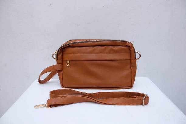 istock brown leather pouch hand bag on an isolated white background 2149687960