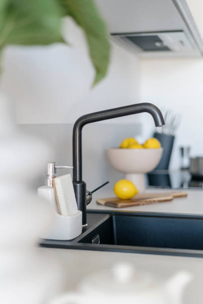 istock Side view on water tap and granite sink on blurred kitchen background 2149688102