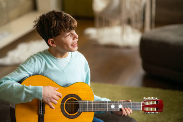 istock Teenage boy playing guitar 2149689205