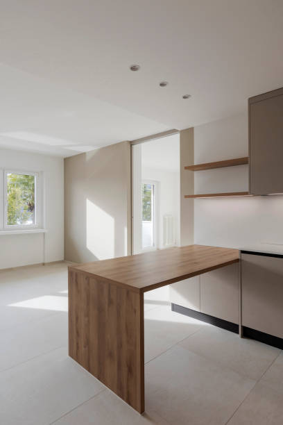 istock Interior of a modern kitchen with a wooden table or worktop. Everything is new and there are no objects around 2149689780