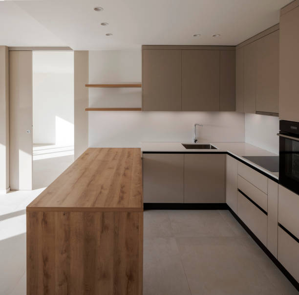 istock Interior of a modern kitchen with a wooden table or worktop. Everything is new and there are no objects around 2149690233