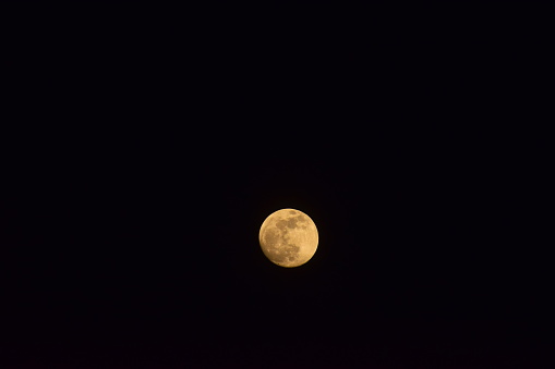 full moon in a starless dark sky